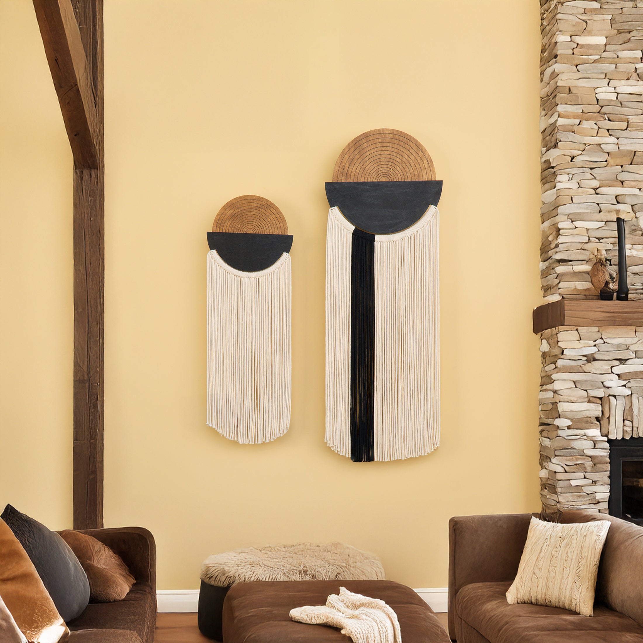 Decorative wall art pieces on a yellow wall with a stone fireplace and brown furniture.