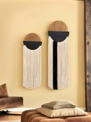 Two decorative wall hangings with circular designs on a beige wall.