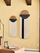 Two decorative wall hangings with circular designs on a beige wall.