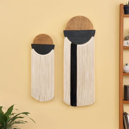 Two wall-mounted decorative items with woven designs on a yellow wall.