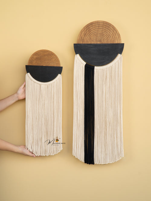 Two wall-mounted woven baskets with black and beige design on a beige background