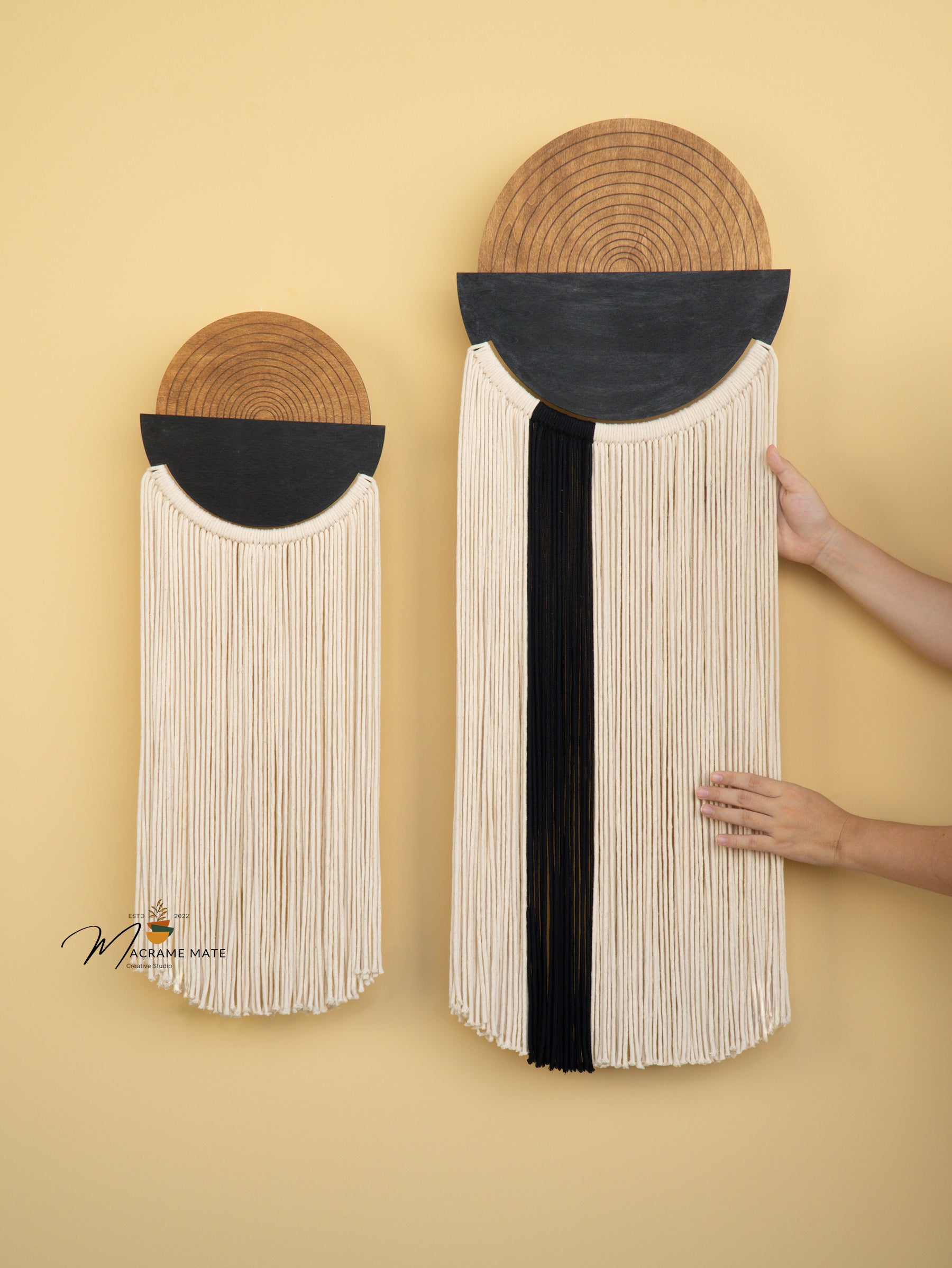 Woven wall art pieces with black and white design on a yellow background