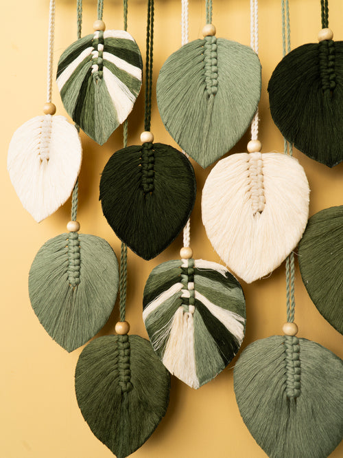 Decorative leaf-shaped ornaments with braided designs on a yellow background