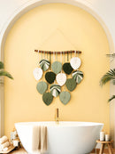Decorative wall hanging with leaf-shaped leaves in a bathroom setting