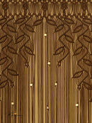 Decorative wall with intricate leaf patterns and hanging lights