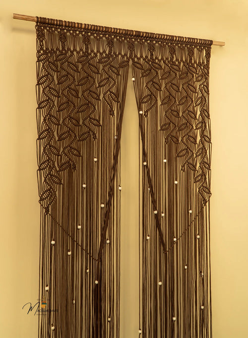 Decorative curtain with macrame design on a beige wall