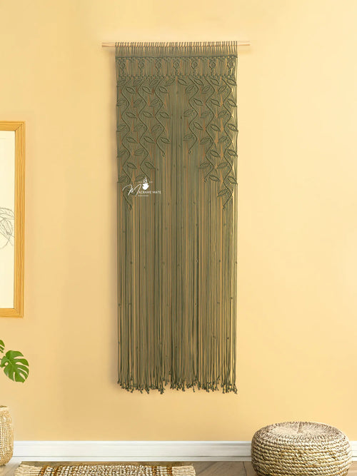 Decorative green curtain with fringe on a beige wall