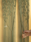 Decorative wall art with leaf patterns on a beige background