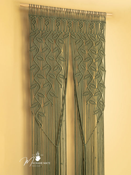 Macrame door curtain with leaf pattern on a beige background, featuring the brand 'Macrame Mate'.