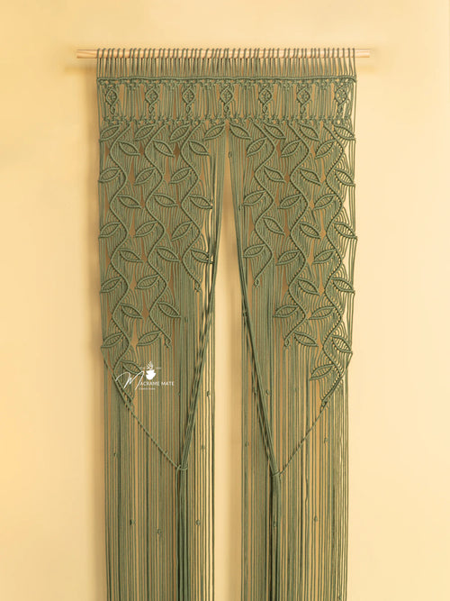 Decorative green curtain with leaf patterns on a beige background