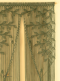 Decorative curtain with intricate leaf pattern on a beige background