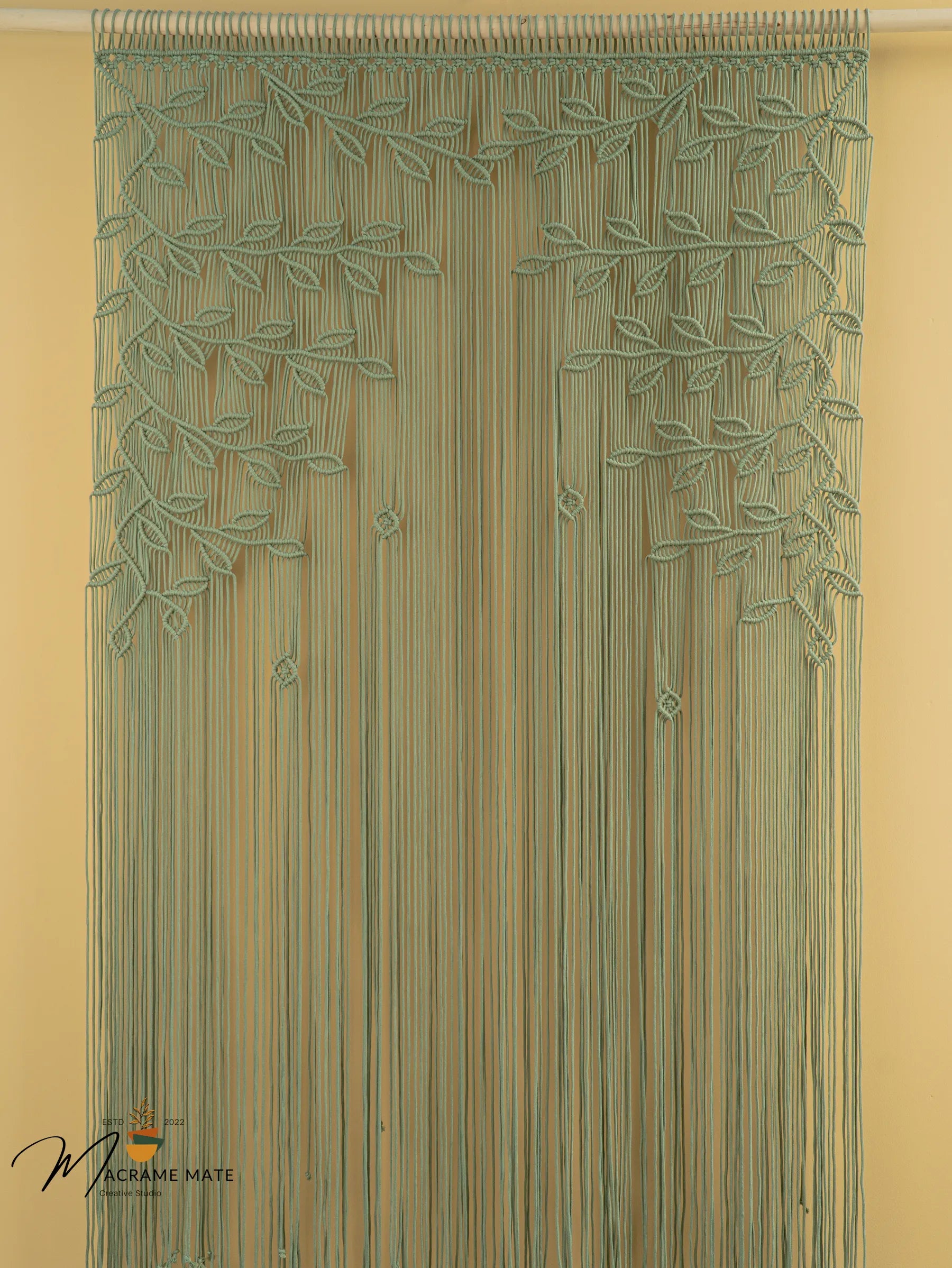 Decorative string curtain with leaf pattern on a beige background