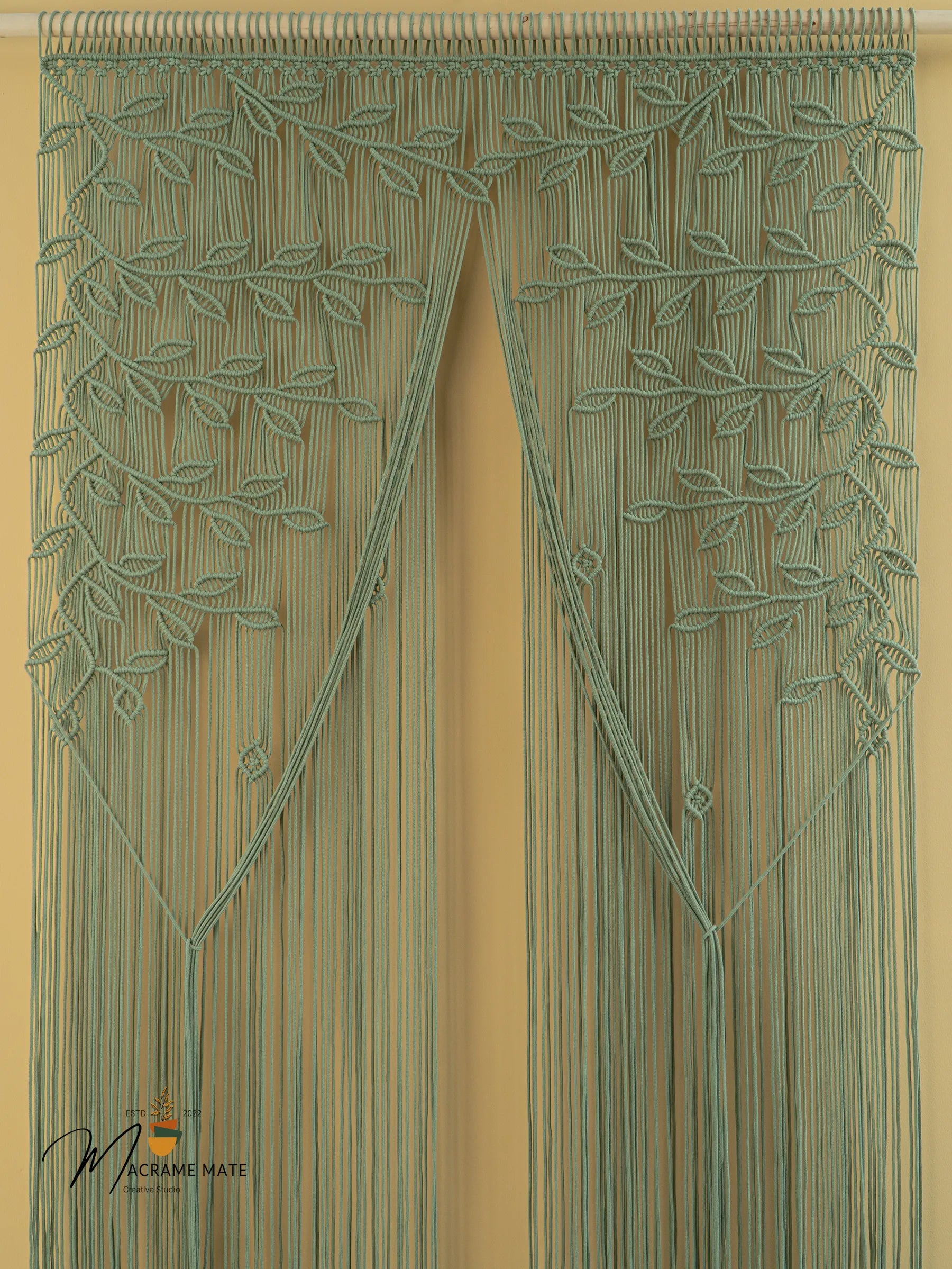 Decorative green curtain with leaf pattern on a beige background