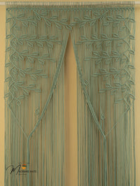 Decorative green curtain with leaf pattern on a beige background