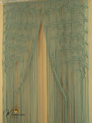 Decorative green beaded curtain with leaf pattern on a beige background