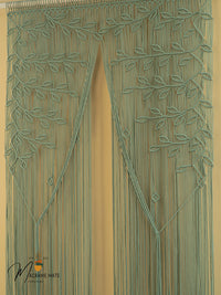 Decorative green beaded curtain with leaf pattern on a beige background