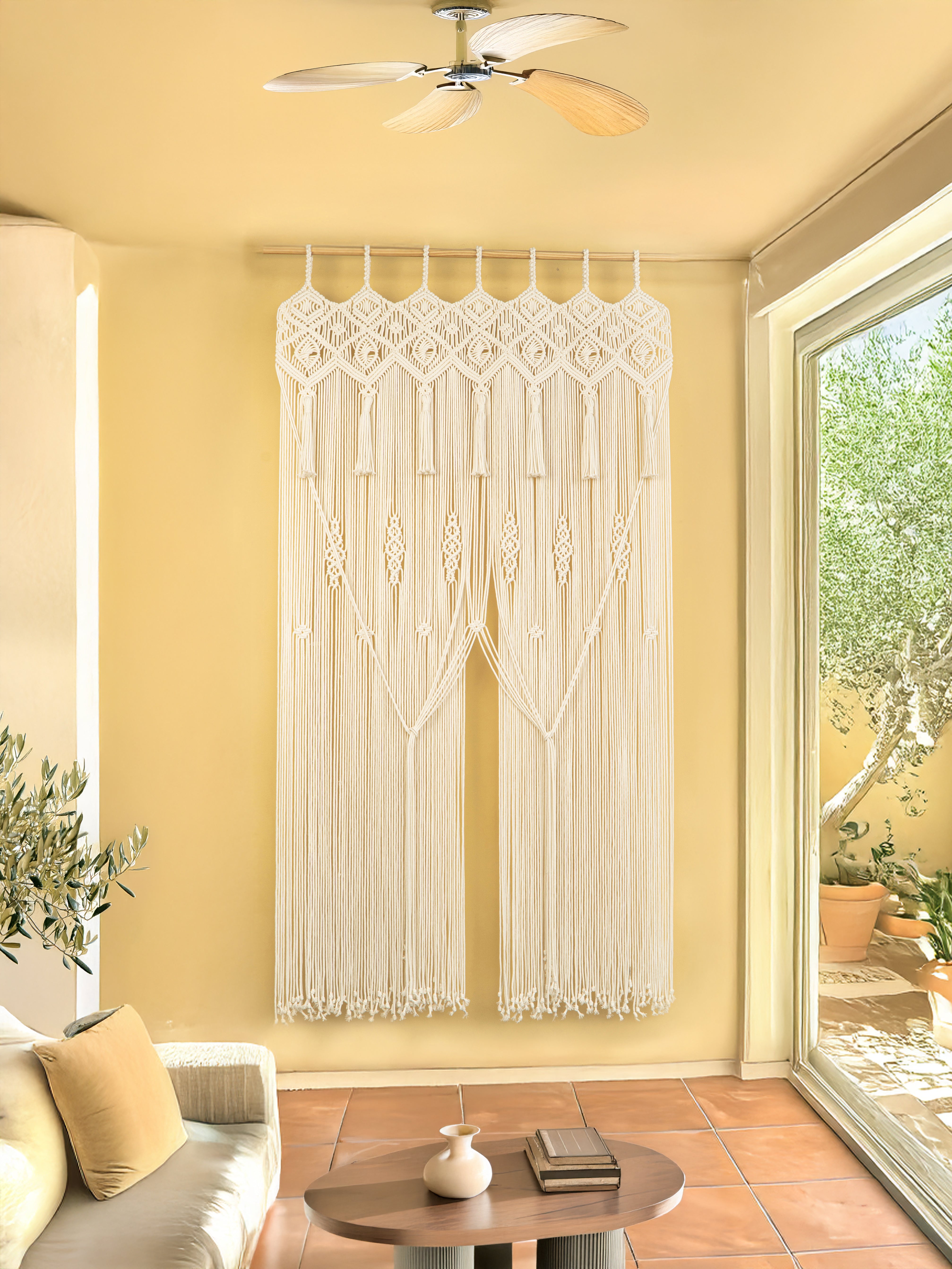 Living room with a decorative white macrame curtain on a yellow wall.