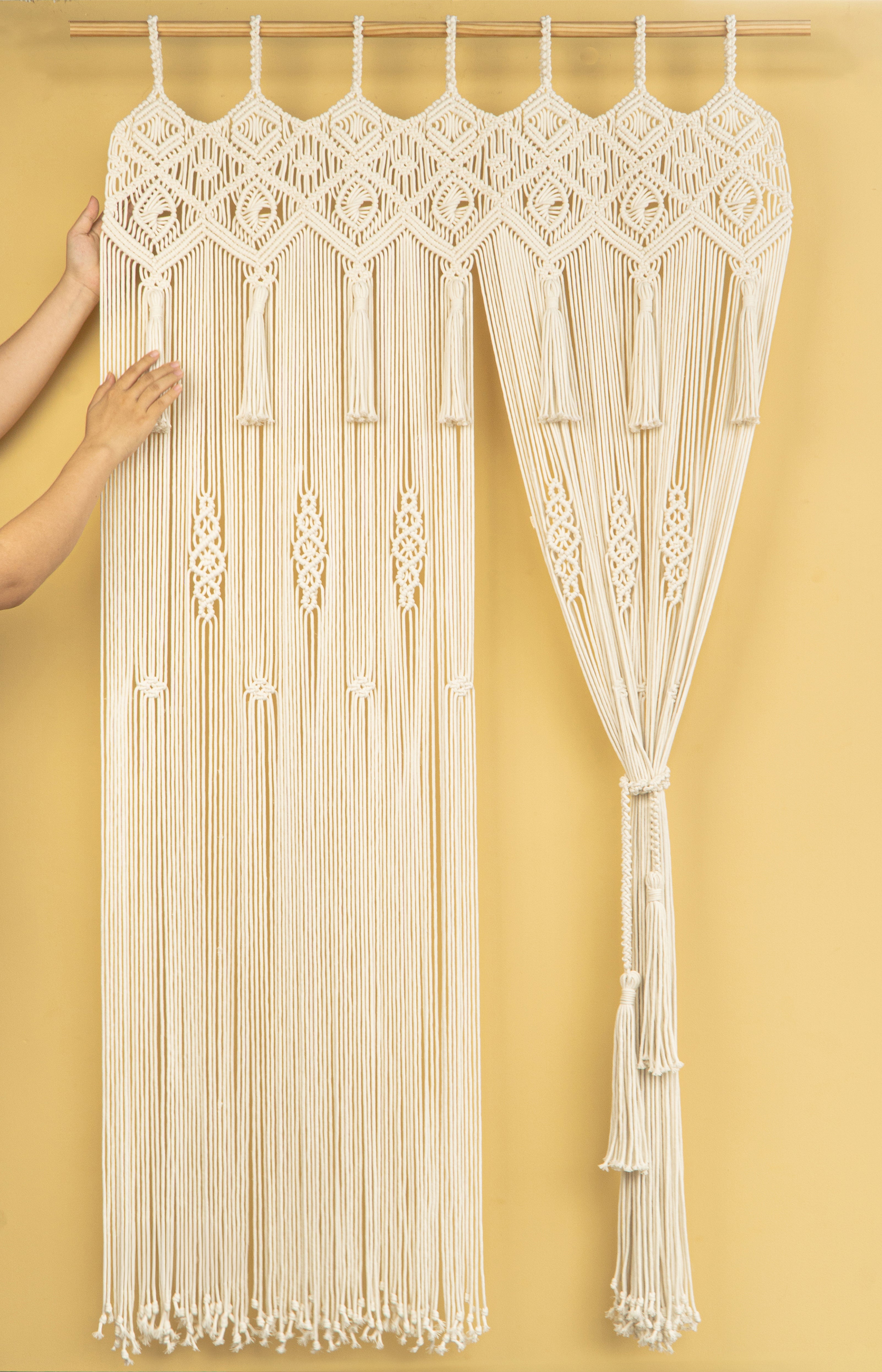 Macrame curtain with intricate patterns on a yellow background