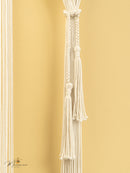 Decorative white tassel against a gold background