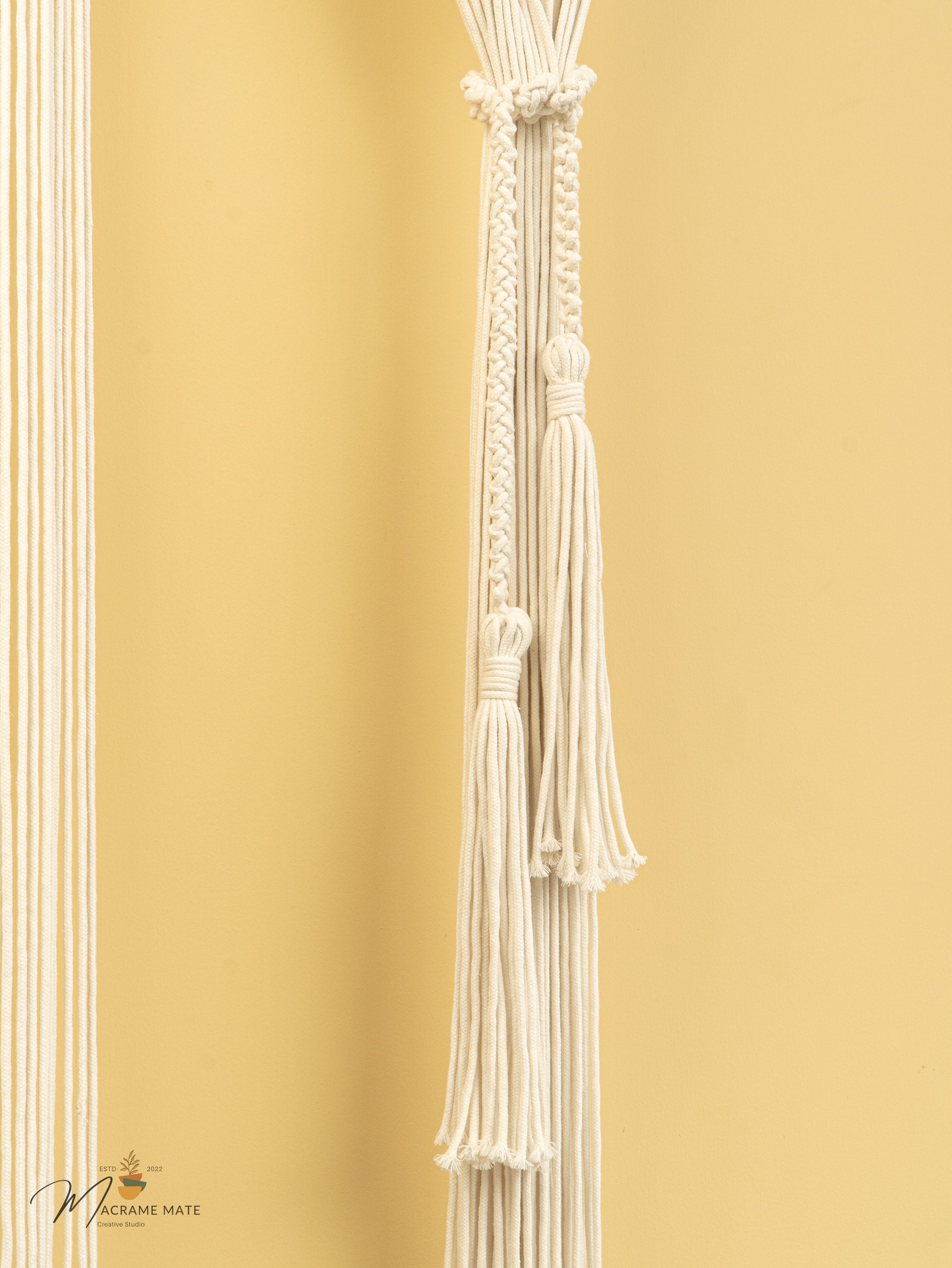 Decorative white tassel against a gold background