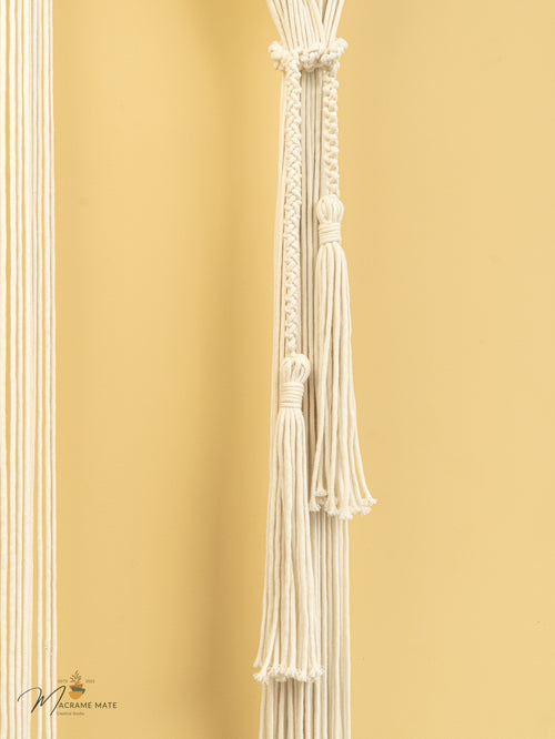 Decorative white tassel against a gold background