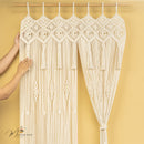Macrame curtain with geometric patterns against a yellow background