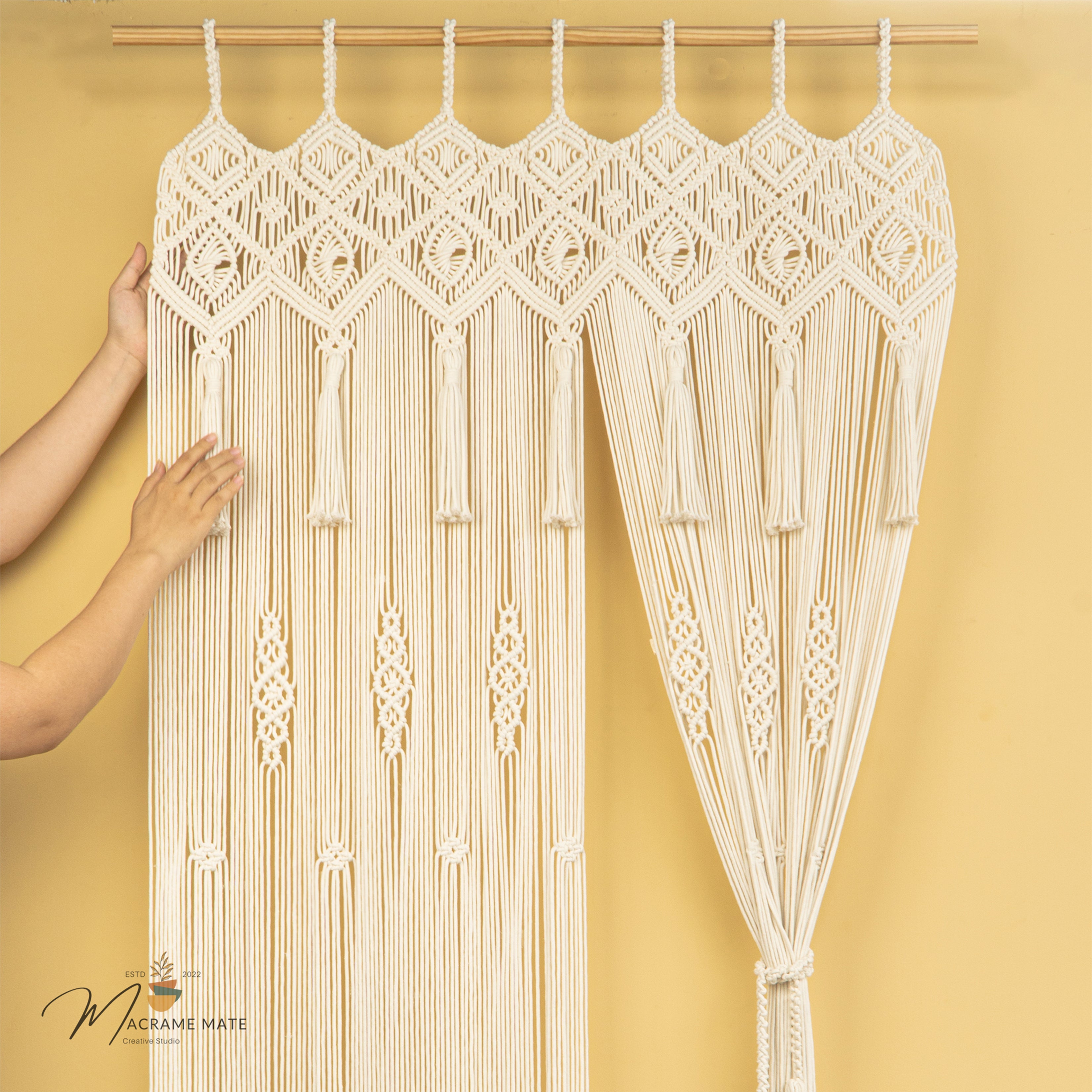 Macrame curtain with geometric patterns against a yellow background