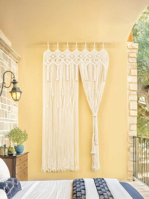 Macrame wall hanging on a yellow wall in a bedroom.