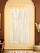 Decorative string curtain hanging in a room with a red armchair and brown walls.