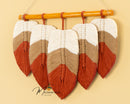 Macrame leaf decor, ideal for minimalist or boho-inspired spaces    
