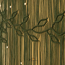 Close-up of a textured wall or wallpaper featuring vertical olive green lines with stylized leafy branches and small white spherical accents on a warm tan background.