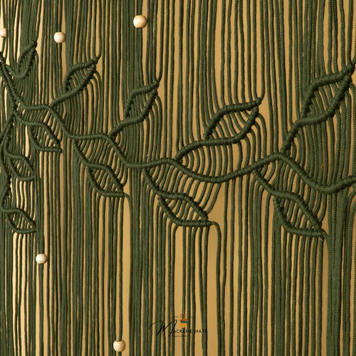 Close-up of a textured wall or wallpaper featuring vertical olive green lines with stylized leafy branches and small white spherical accents on a warm tan background.