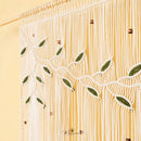 A close-up of a textured fabric or wallpaper pattern featuring dark green rope-like leafy vines over a vertical striped background of olive green and tan.
