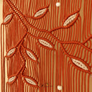 A close-up of a textured fabric or wallpaper featuring a vertical striped pattern in olive green and mustard yellow, decorated with a horizontal vine of pink leaves and small white bead accents.
