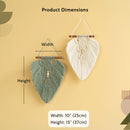 Product dimensions diagram showing two woven wall hangings on a beige background, with labels for width and height and size measurements: 10 inches by 15 inches (25 cm by 37 cm). One hanging is sage green and one is cream.