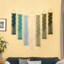 Set of six decorative wall hangings in various colors on a yellow wall above a sofa.