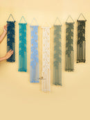 Set of six macrame wall hangings in various colors on a yellow background