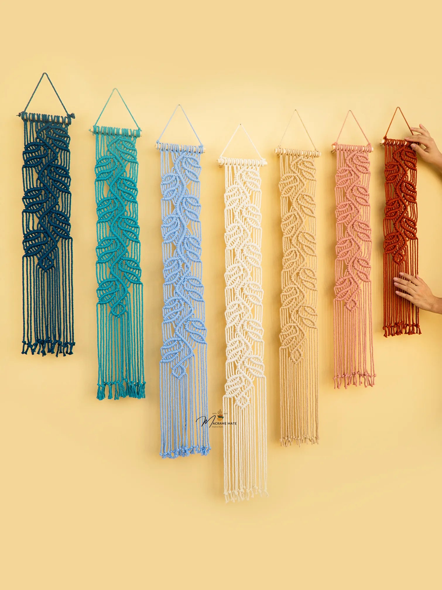 Set of six colorful wall hangings with intricate patterns on a yellow background