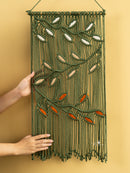 Macrame wall hanging with leaf patterns on a yellow background
