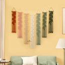 Set of six decorative wall hangings with leaf patterns on a yellow wall.