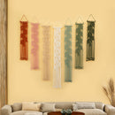 Set of six string art wall decorations on a beige wall above a sofa.