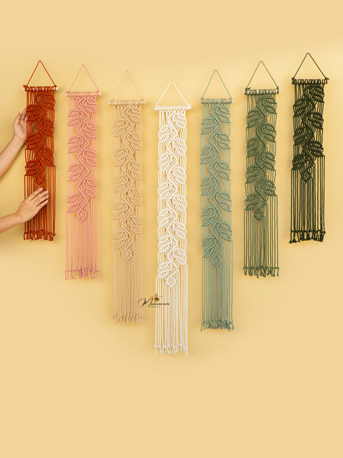 Set of six macrame wall hangings in various colors on a yellow background