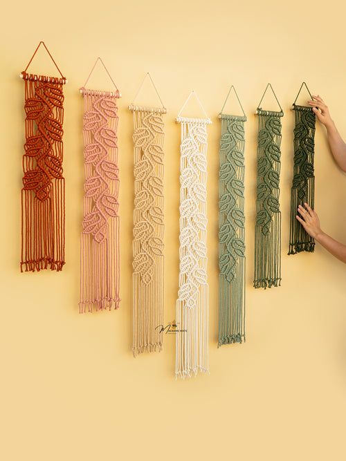 Set of six macrame wall hangings in various colors on a yellow background.