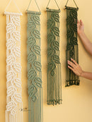 Four macrame wall hangings of different designs on a yellow wall.
