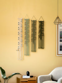 Decorative wall hangings on a yellow wall with a modern interior setting.